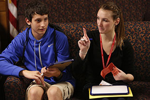 Photo of two students talking. 